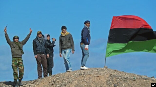 Rebel fighters at positions outside Brega, Libya, show their support for the opposition and their enthusiastic belief that they will overthrow the government in Tripoli, March 10, 2011