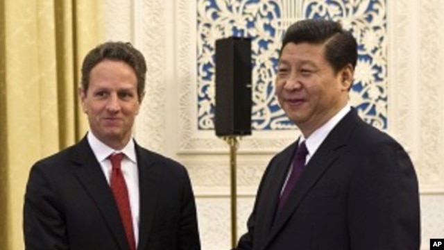 U.S. Treasury Secretary Timothy Geithner, left, shakes hands with Chinese Vice President Xi Jinping at the Great Hall of the People in Beijing, January 11, 2012