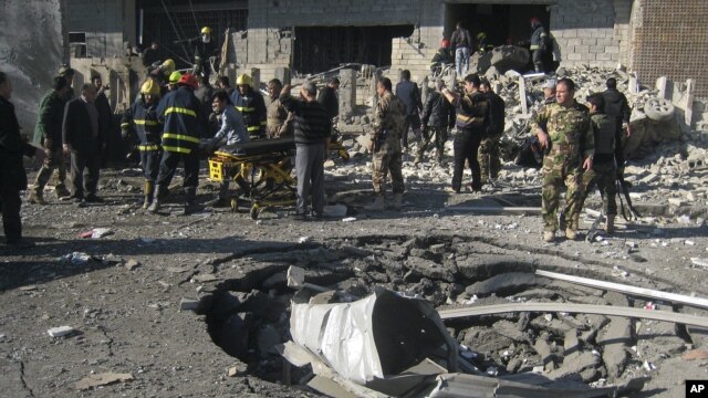 Iraqi civilians and security forces inspect a crater caused by a car bomb attack in Kirkuk, 180 miles (290 kilometers) north of Baghdad, Iraq, February 3, 2013. 