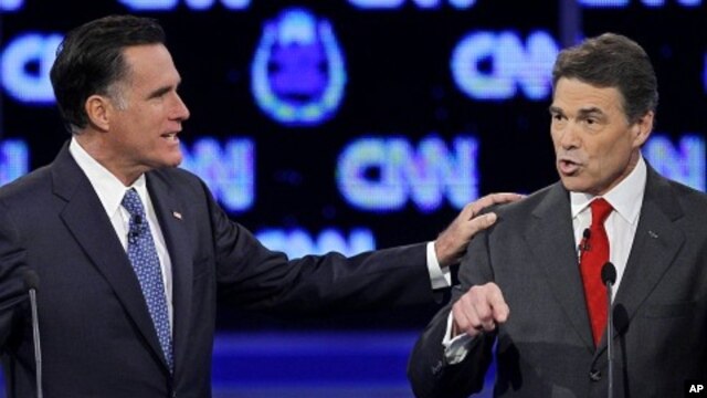 Republican presidential candidate former Massachusetts Gov. Mitt Romney, left, and Texas Gov. Rick Perry speak during a Republican presidential debate October 18, 2011, in Las Vegas.