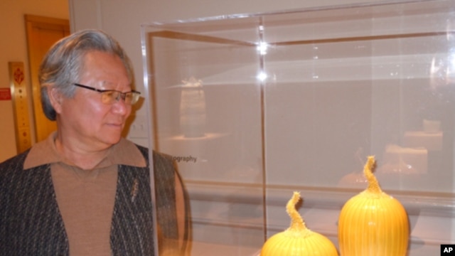 Ceramic artist Cliff Lee - pictured with his porcelain 'Prickly Melon' featuring his signature yellow glaze - combines his background as a neurosurgeon with his passion for clay to create exquisite objects inspired by his Chinese heritage.