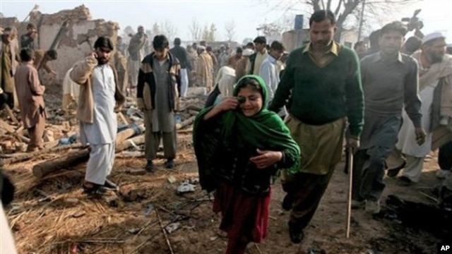 A Pakistani girl whose father is injured in a car bomb blast which killed many people, walks at the site of explosion in suburbs of Peshawar, Pakistan, February 02, 2011.