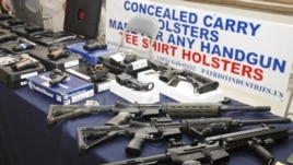 Guns are displayed during a rally at the state Capitol in Oklahoma City, Oklahama, May 8, 2012.