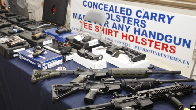 Guns are displayed during a rally at the state Capitol in Oklahoma City, Oklahama, May 8, 2012.