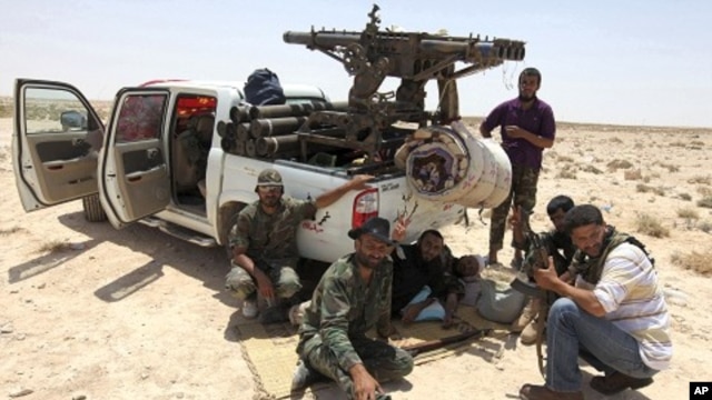 Libyan rebels make their way to frontline, 40 km west of Ajdabiyah, July 18, 2011