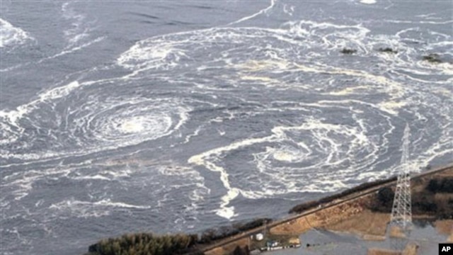 Swirls of waves approach to a coast in Iwaki, Fukushima Prefecture, northern Japan, March 11, 2011 after a powerful tsunami spawned by the largest earthquake in country's recorded history slammed the eastern coast