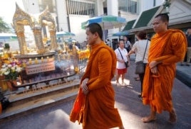 Thai Buddhist monks arrive at the Erawan Shrine at Rajprasong intersection in Bangkok, Thailand, Wednesday, Aug. 19, 2015.