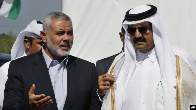 Emir of Qatar Sheikh Hamad bin Khalifa al-Thani, right, and Gaza's Hamas prime minister Ismail Haniyeh, left, during Emir's  visit to Gaza Oct. 23, 2012.