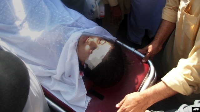 Pakistani hospital workers carry injured Malala Yousafzai, 14, on a stretcher at a hospital following an attack by gunmen in Mingora on October 9, 2012.