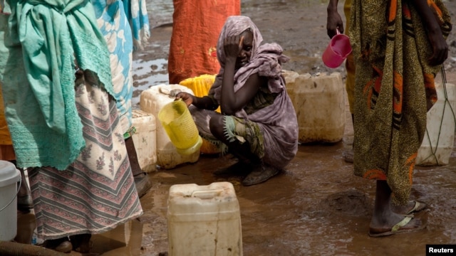 A woman waits in queue to collect water at Yusuf Batil refugee camp, Upper Nile, South Sudan, July 4, 2012.