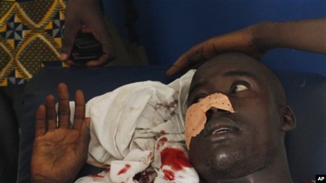 A man who says he was shot in the face by security forces loyal to Laurent Gbagbo while walking home in the Abobo neighborhood waits to receive stitches at a health clinic in the Anyama suburb of Abidjan, Ivory Coast, March 12, 2011