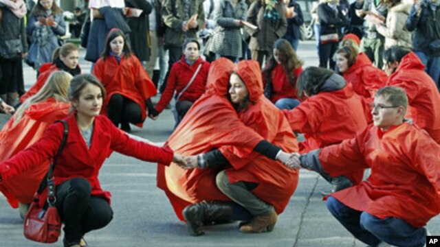Romanian volunteers hold their hands forming a red ribbon, the anti-AIDS symbol, during an awareness rally two days before World AIDS day, in central Bucharest, Romania, November 29, 2011.