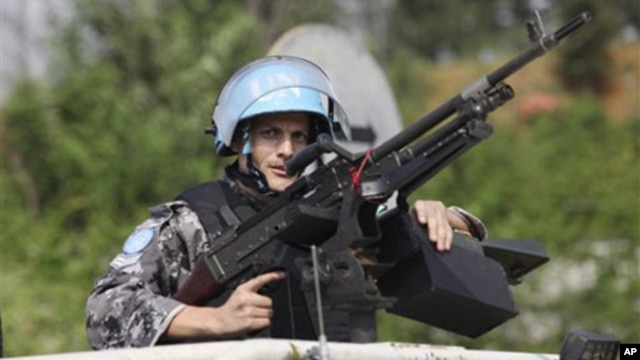 UN forces patrol outside the UN headquarters in Ivory Coast, Abidjan, Ivory Coast, Tuesday, Dec. 21, 2010.