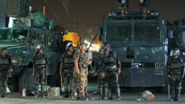 Riot policemen stand guard outside the French embassy in Sanaa, Yemen, September 19, 2012.