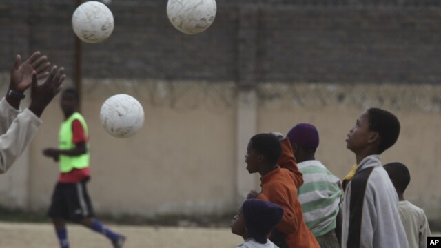 Children attend football training at a ground in Alexandra Township, north of Johannesburg on June 30, 2010.  Memories of South Africa 2010 World Cup are fading fast, as its progress  halted by a scandal-ridden period off the field since the historic tournament. 