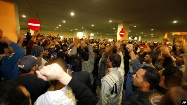 People gather to mourn and protest for demonstrators who were injured after riot police stormed an anti-government protest camp in Manama, February 17, 2011