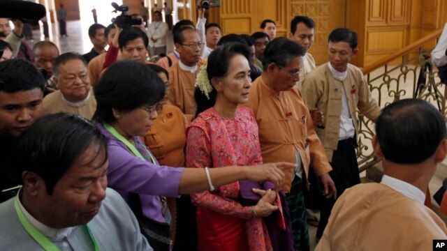 Myanmar’s pro-democracy leader Aung San Suu Kyi, center, arrives to participate in the inauguration session of Myanmar's lower house parliament in Naypyitaw, Myanmar, Feb. 1, 2016.  
