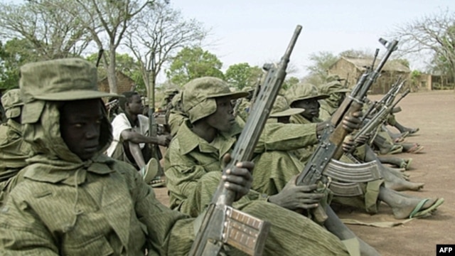 Child soldiers of the Sudan People's Liberation Army wait in a file photograph from 2001.