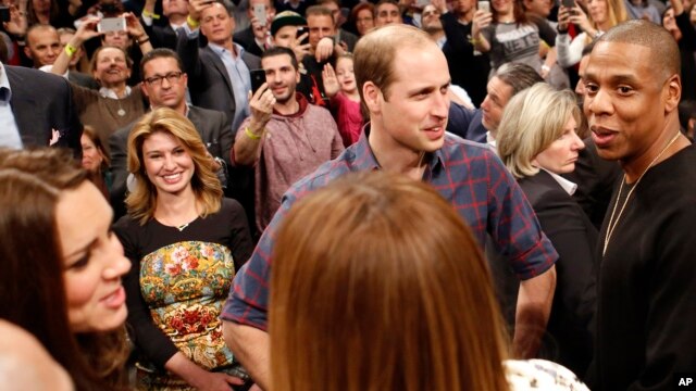 Britain's Prince William, second from right, talks with rapper and entrepreneur Jay-Z , far right, as Kate, left, the Duchess of Cambridge, chats with Jay Z's wife, entertainer Beyonce, foreground center, in New York, Dec. 8, 2014.