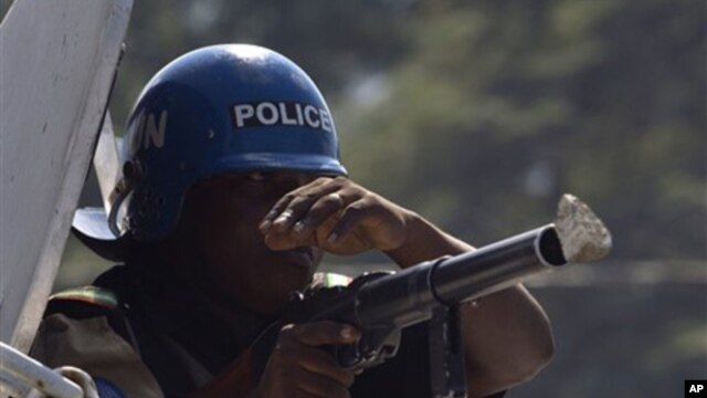 A stone hits the gun of a UN peacekeeper from Nigeria during a protest in Port-au-Prince, Haiti, Thursday, Nov. 18, 2010.