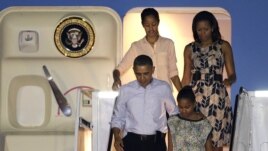 President Barack Obama arrives with first lady Michelle Obama, top, and daughters Malia, top left, and Sasha, bottom right, at Honolulu Joint Base Pearl Harbor-Hickam in Honolulu, for the start of their holiday vacation, Saturday, Dec. 22, 2012. 