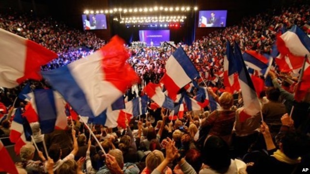 Supporters of France's president and candidate for re-election in 2012, Nicolas Sarkozy, wave French national flags, during a campaign meeting, in Toulon, southern France, May 3, 2012. 