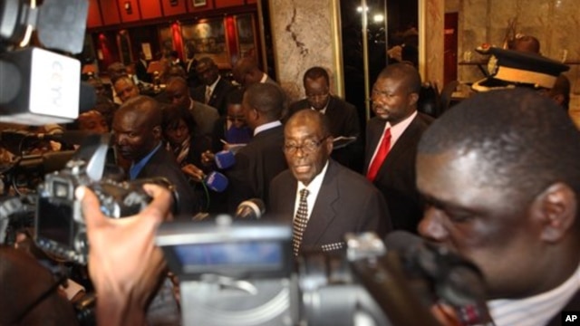 Zimbabwean President Robert Mugabe (C) briefs journalists after meeting with Prime Minister Morgan Tsvangirai and South African President Jacob Zuma on the progress made on the implementation of The Global Political Agreement ahead of anticipated election