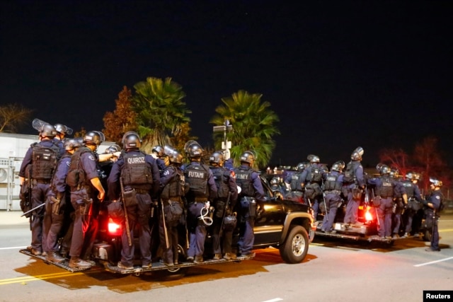 Police follow protesters during a march in Los Angeles, California, following Monday's grand jury decision in the shooting of Michael Brown in Ferguson, Missouri, November 25, 2014.