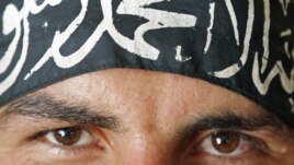 A Free Syrian Army fighter in Aleppo wears a headband reading the Islamic declaration of faith, "There is no God but God, and Mohammed is His Messenger."