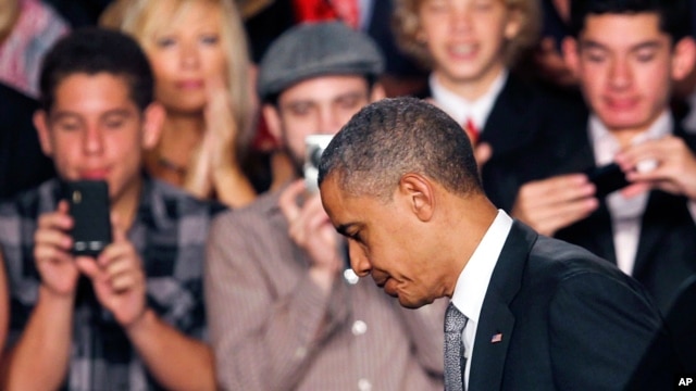 President Barack Obama walks off the stage after speaking about the Aurora, Colorado shooting in Fort Myers, Florida, July 20, 2012.