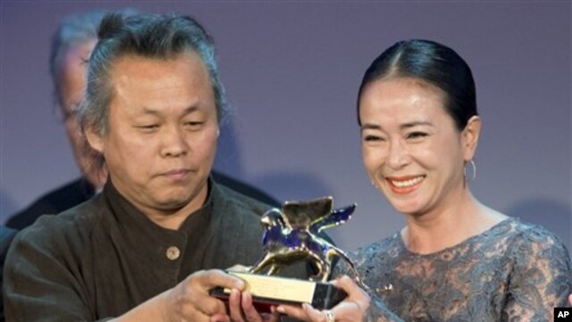 Đạo diễn Kim Ki-duk (trái) và diễn viên Cho Min-soo nhận giải thưởng Sư Tử Vàng cho phim Pieta tại Liên hoan phim Venice