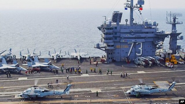 South Korean Sea Hawk helicopters land aboard the aircraft carrier USS George Washington during joint South Korean, U.S. military exercises, 27 July 2010