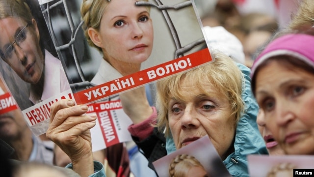 Supporters of Ukraine's jailed former Prime Minister Yulia Tymoshenko hold up posters of Tymoshenko, during a rally near the high court building in Kiev, August 29, 2012.