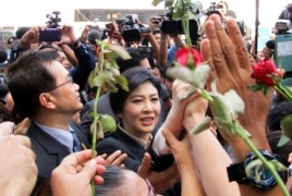 Thailand's former Prime Minister Yingluck Shinawatra, center, walks through supporters as she leaves the Supreme Court in Bangkok, Thailand, Tuesday, May 19, 2015.