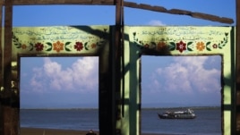 A boat is framed by the ruins of a destroyed mosque in a part of Pauktaw township that was burned in recent violence in Rakhine state, Burma, October 27, 2012.