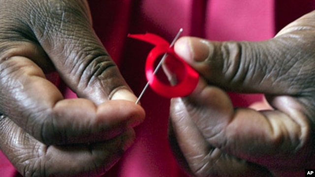 A Kenyan woman prepares ribbons ahead of World Aids Day at Beacon of Hope center, a non-government organization that addresses women's problem of HIV/AIDS in Nairobi