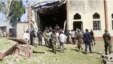 Soldiers stand guards outside St. Rita's Catholic church following a suicide bombing in Kaduna, Nigeria, October 28, 2012.