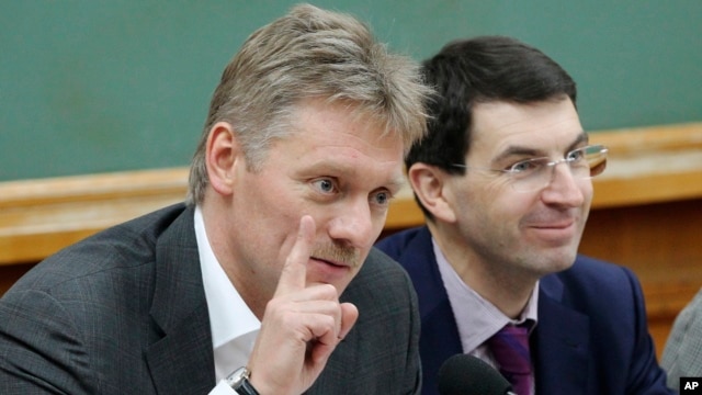Russian President Vladimir Putin's spokesman Dmitry Peskov, left, speaks during a meeting in Moscow, Russia, Dec. 9, 2012. 