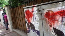Posters of Eygptian presidential candidate Ahmed Shafiq defaced outside his Cairo headquarters, May 29, 2012. (Elizabeth Arrott/VOA)