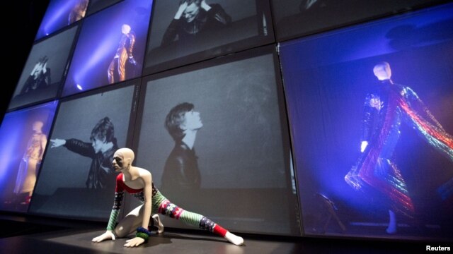A striped asymmetric catsuit by Yansai Yamamoto (1973), used by performer David Bowie, is seen at the "David Bowie is" Exhibition in London, March 20, 2013.