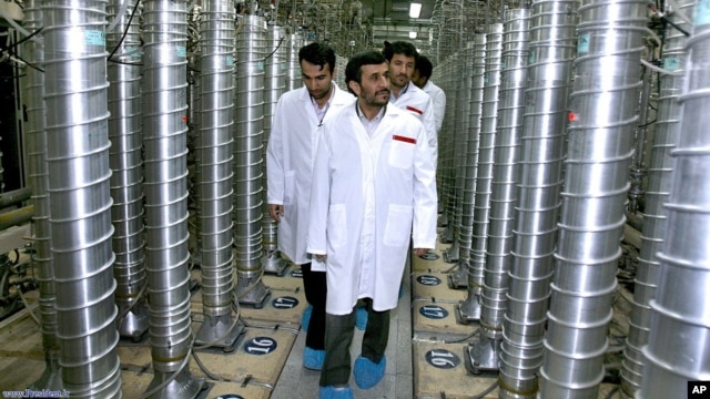 FILE - Iranian President Mahmoud Ahmadinejad, center, visits Natanz Uranium Enrichment Facility, some 200 miles (322 kilometers) south of Tehran, April 8, 2008.
