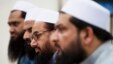 FILE - Hafiz Saeed, second from right, chief of Pakistani religious group Jamaat-ud-Dawa listens to reporters at a news conference in Islamabad, Pakistan, Nov. 2, 2015.
