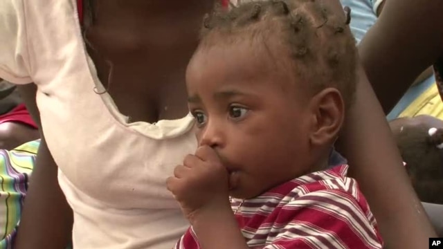 Child in shelter for earthquake survivors in Haiti