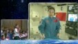In this image taken and made from CCTV, Chinese astronaut Wang Yaping, seen on screen, listens to a question from a school girl in Beijing, China, during a live broadcast from onboard the Tiangong 1 prototype space station, June 20, 2013.