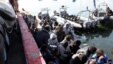 Migrants sit in a port, after being rescued at sea by Libyan coast guard, in Tripoli, Libya, April 11, 2016.