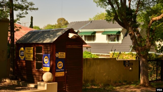 A security hut on a street in Parkhurst, Johannesburg, South Africa, October 2012. Many neighborhoods have a security guard posted on their street at all times. (P. Cox/VOA)