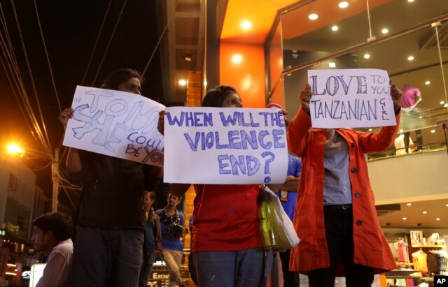 FILE - Indian students hold placards during a protest against the alleged molestation of a Tanzanian girl, in Bangalore, India on Feb. 4, 2016.