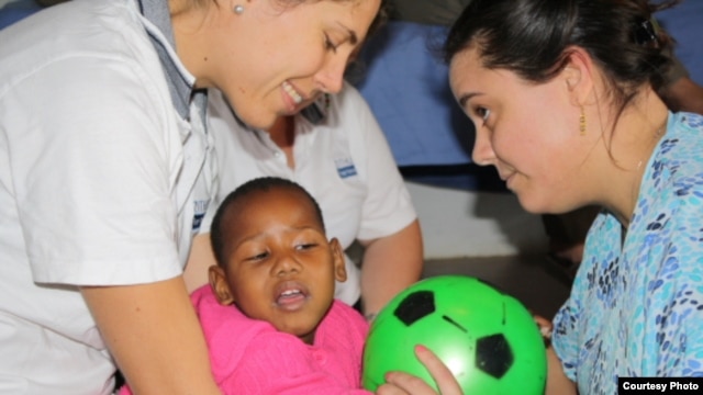 Laura Grobicki (left) and Stephanie Benn give therapy to a patient with cerebral palsy at Zithulele Hospital in South Africa ( Photo D.Taylor)        