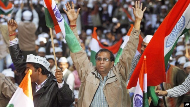 Supporters of Indian anti corruption activist Arvind Kejriwal, unseen, cheer at the formal launch of his political party 'Aam Aadmi Party (AAP)' in New Delhi, November 26, 2012.
