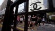 Shoppers walk across Canton Road, famous for its luxury brand stores, at Hong Kong's Tsim Sha Tsui shopping district, May 9, 2013.